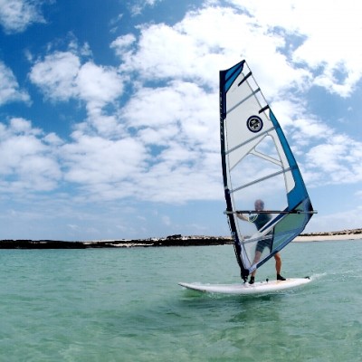 Learning windsurfing in fuerteventura in the shallow waters on Cotillo lagoon