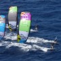 Group of advanced kiteboarders racing in north Fuerteventura